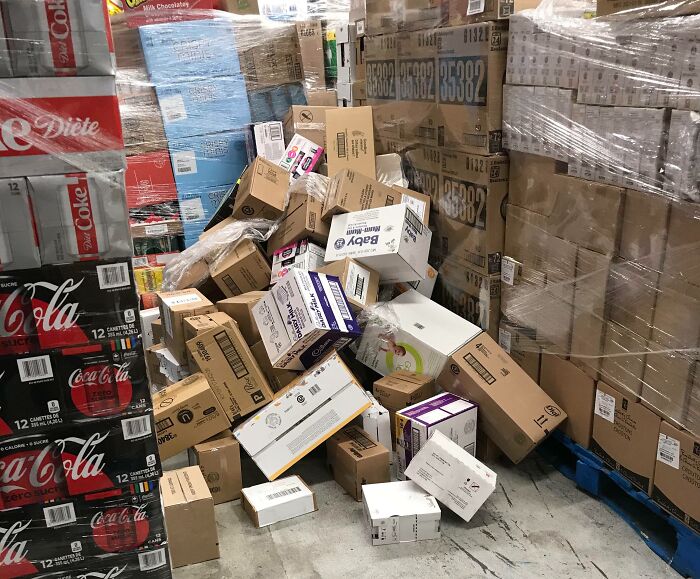 Boxes and pallets stacked messily in a warehouse, showing lack of cooperation and selfishness in teamwork.