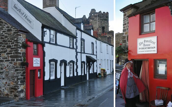 Smallest House in Great Britain with red facade, a stone wall, and a person dressed in historic costume outside, unusual places.
