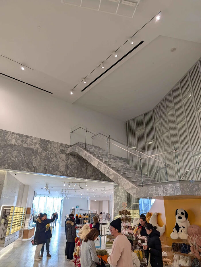 Modern retail store with glass staircase showing one job fail in design, illustrating common sense not being common.