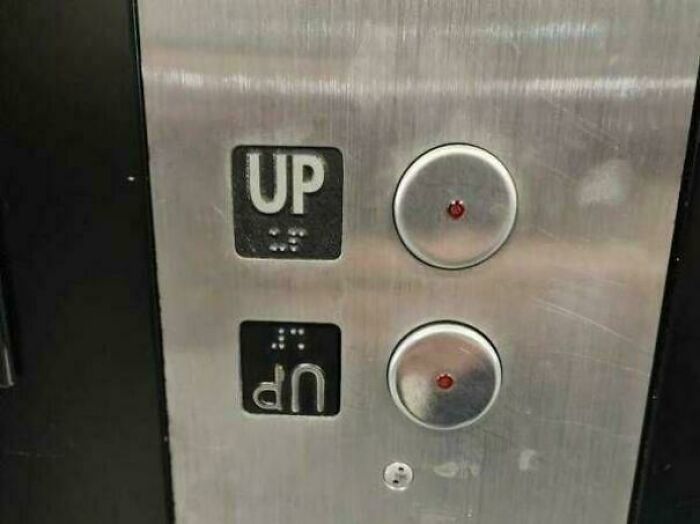 Elevator panel with two upside down up buttons showing a you had one job fail with poor common sense design.
