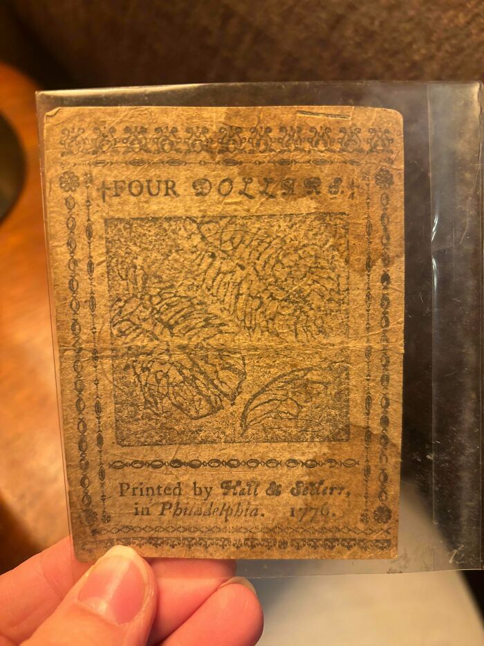 Close-up of an old four-dollar bill from 1776, a rare jackpot item from a thrift store.