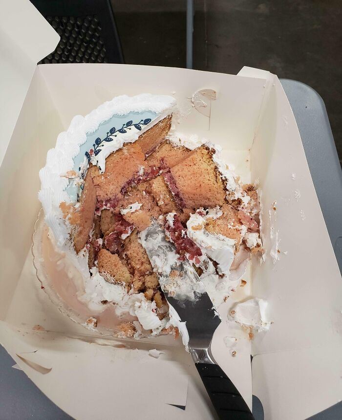 Partially smashed cake in a box with knife showing selfish and stupid behavior refusing to work with others.