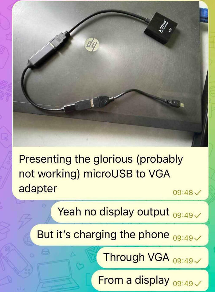 MicroUSB to VGA adapter connected to a laptop, highlighting a tech support worker's frustrating experience with hardware.