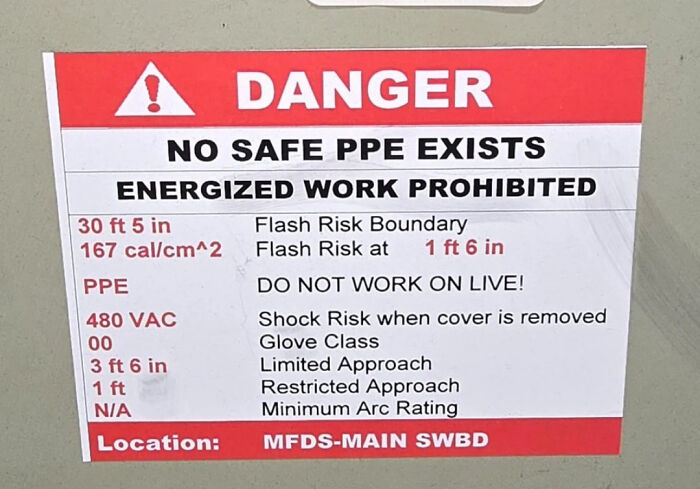 Danger sign warning no safe PPE, energized work prohibited with flash and shock risks in industrial setting.