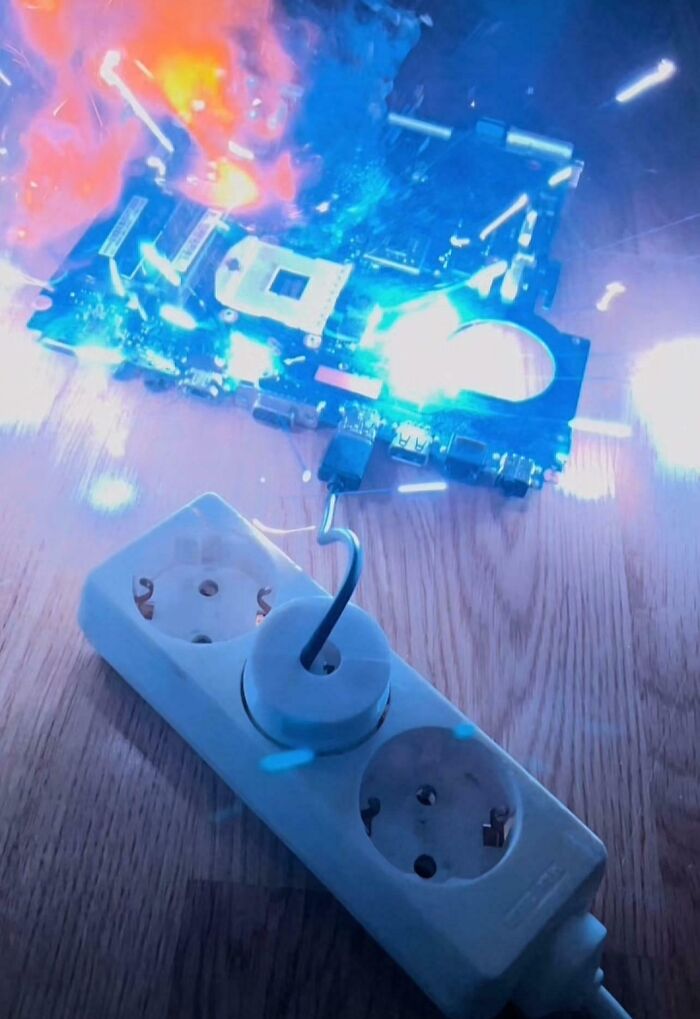 Circuit board sparking and catching fire while plugged into a power strip illustrating tech support workers' frustrations.