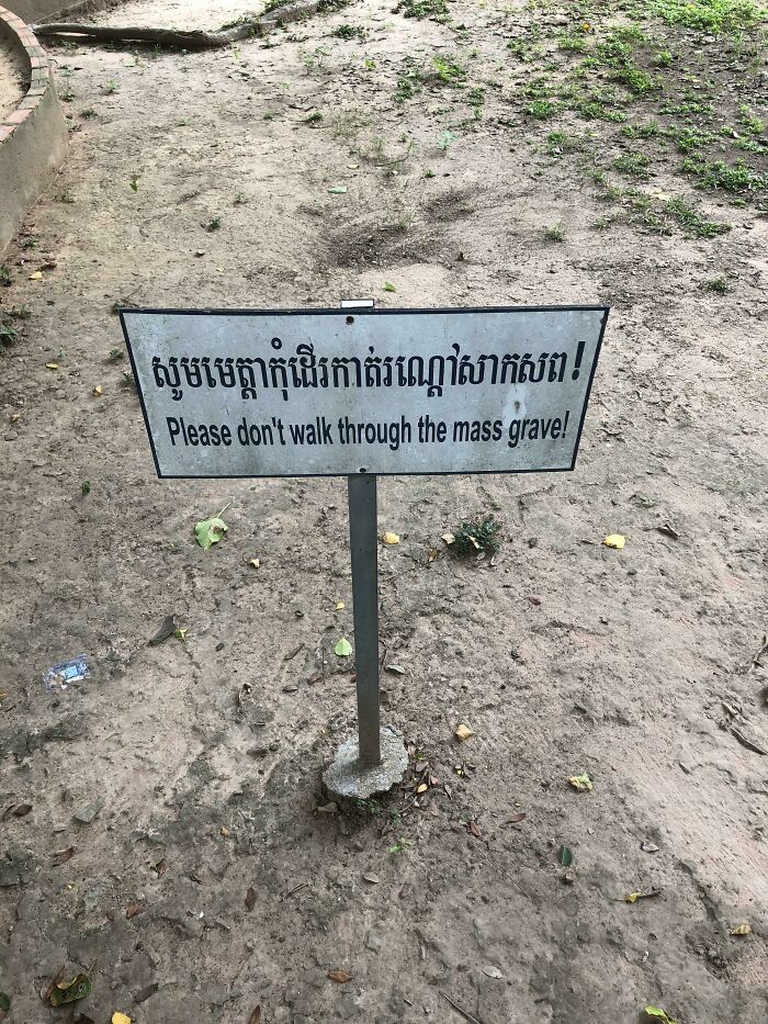 Warning sign in English and Khmer asking people not to walk through the mass grave, one of the scariest signs spotted in the wild.