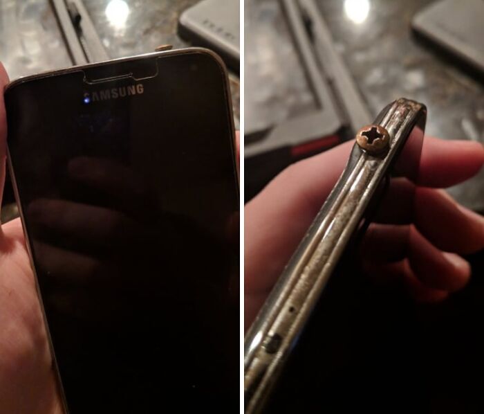 Samsung smartphone with a rusty s***w inserted on the side, illustrating boomers trying to use technology and failing.