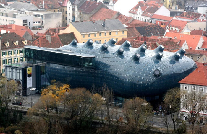 A unique, futuristic building that appears to be built for an evil mastermind, resembling a giant blue slug with protrusions.