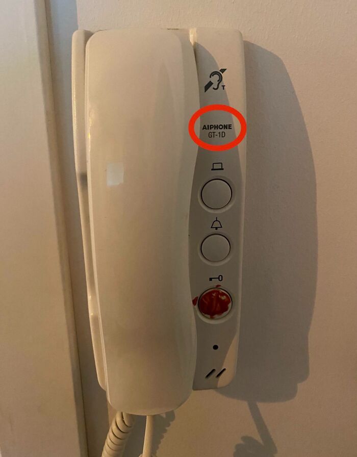 Old-fashioned wall intercom phone with buttons, highlighting boomer technology struggles in using modern devices.