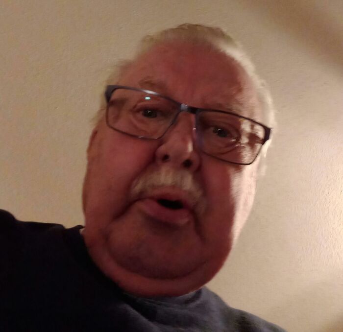 Older man wearing glasses with a confused expression illustrating boomers trying to use technology and failing miserably.