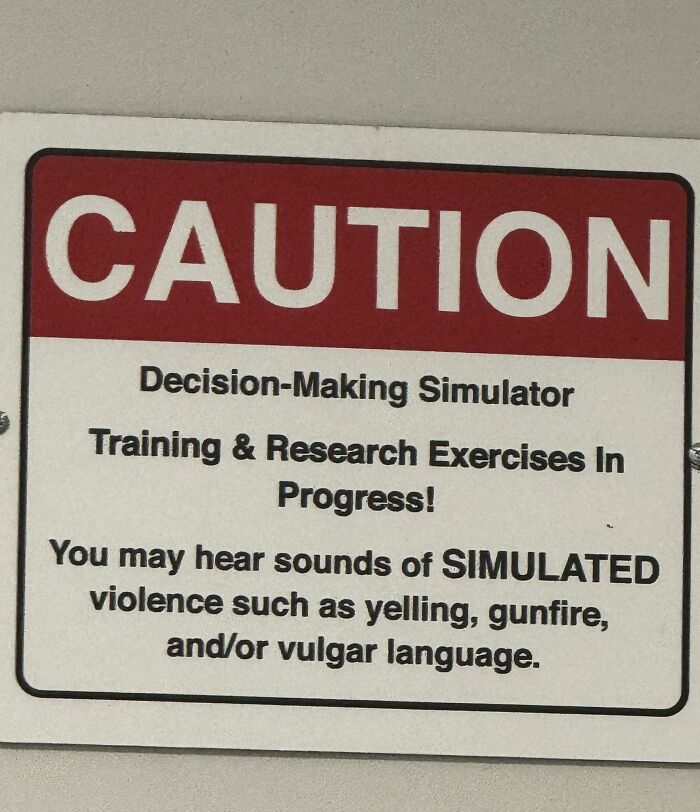 Caution sign warning of decision-making simulator with simulated violence sounds including yelling, gunfire, and vulgar language.