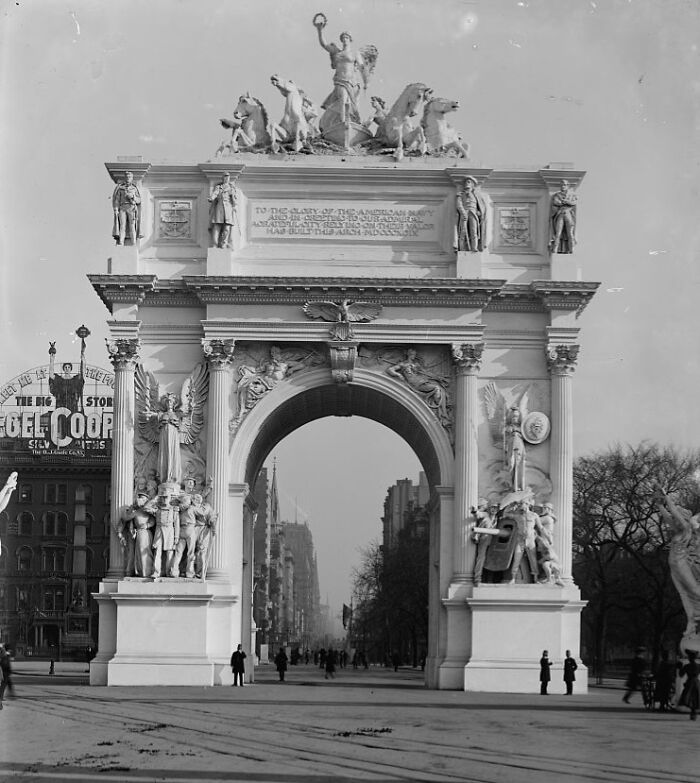 Historic arch with detailed sculptures and figures, an interesting building lost as the world changed over time.