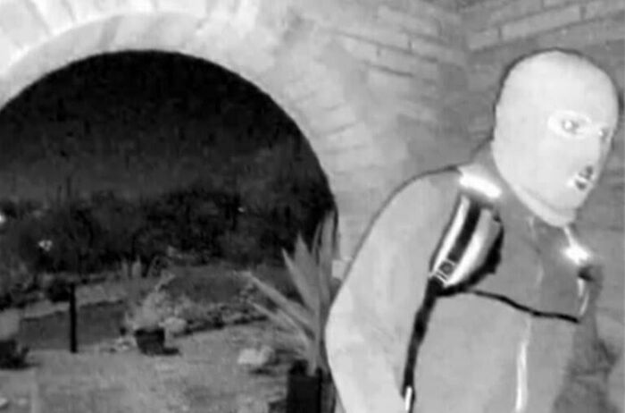 A blurry, greyscale infrared image shows a person in a balaclava, part of creepy images involving kids and babysitting.