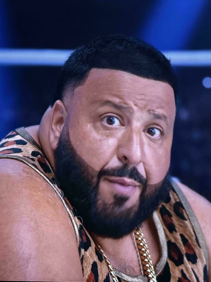DJ Khaled with a meticulously shaped beard and an unfortunate haircut, wearing a leopard print tank top.
