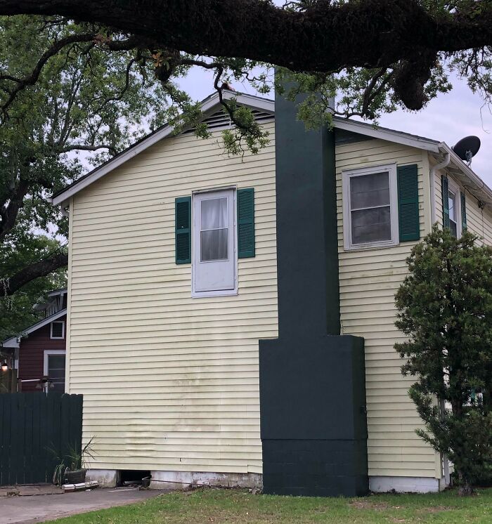 House exterior with a door leading nowhere, showcasing a clear example of architects failing at their jobs and design flaws.