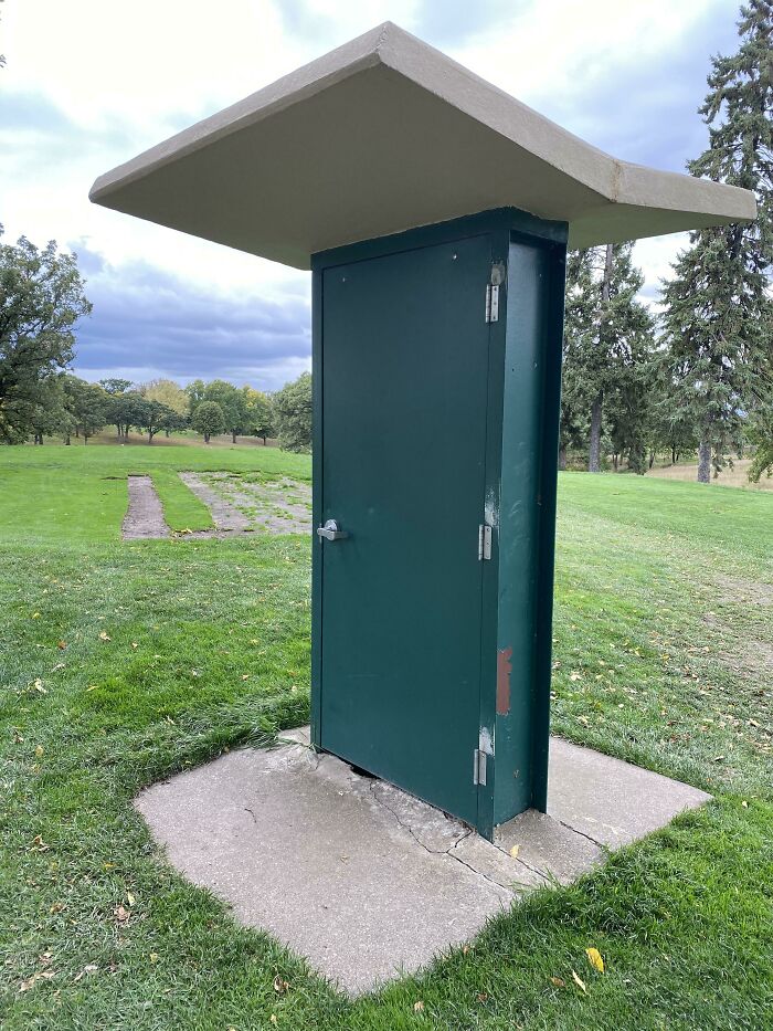 Door installation fails with a standalone door in green leading absolutely nowhere on a grassy field.