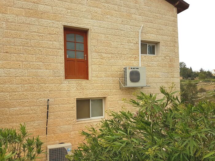 Door leading absolutely nowhere on the side of a building, showing a classic architectural fail by architects.