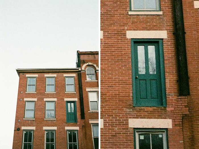 Green door on the second floor of a brick building leads absolutely nowhere, showcasing a notable architectural fail.