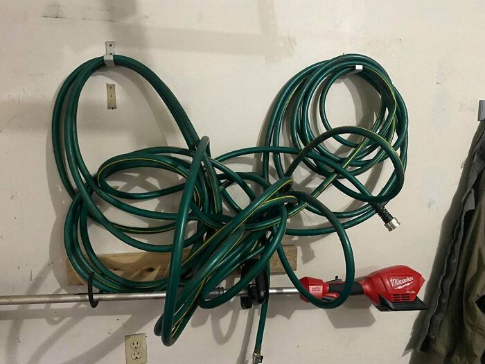 Messy garden hose tangled on a hook, demonstrating one of the most frustrating partner habits shared by people.