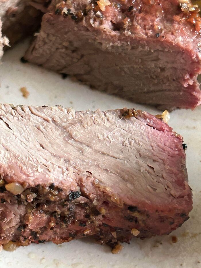Close-up of sliced steak showing a partner's most ridiculously frustrating habit with cooking and food preparation.