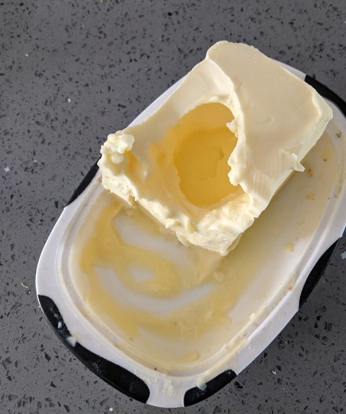 Container of butter with a large scoop missing from the middle, showing a frustrating habit shared by partners.