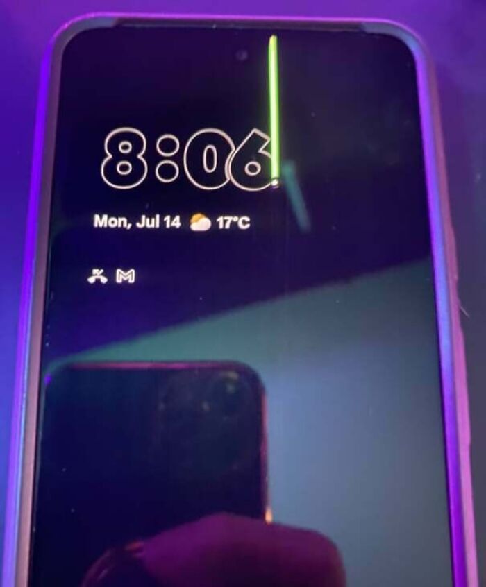 Smartphone screen showing a persistent bright vertical green line, illustrating a partner’s frustrating habit with their device.