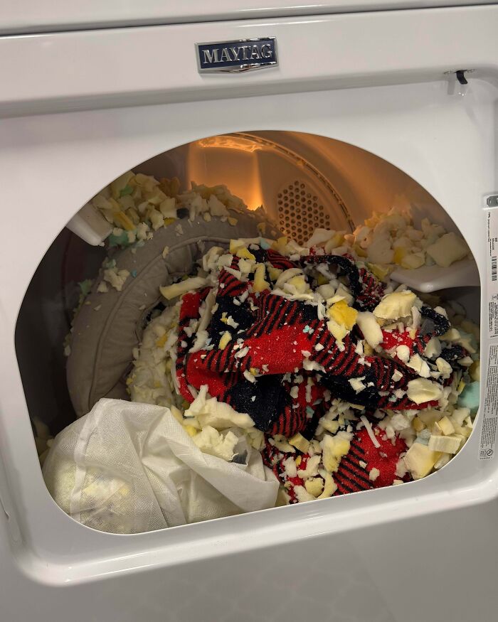 Clothes covered in foam pieces inside a dryer showing a partner’s most ridiculously frustrating habits.