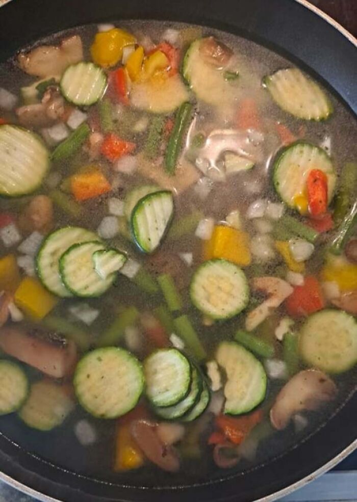 Close-up of a cooking pan filled with sliced vegetables illustrating a partner’s frustrating habit.