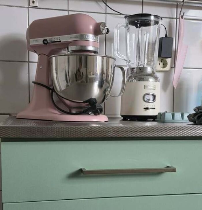 Kitchen counter with a pink mixer and blender, showing a partner's frustrating habit of tangled appliance cords.
