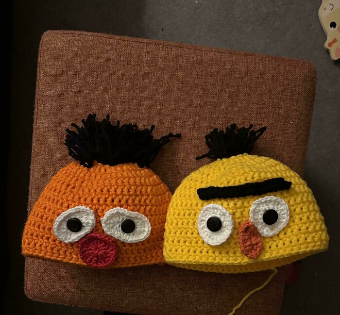 Two awesome crocheted hats, one orange and one yellow, resembling Angry Birds characters. People crocheted something awesome here!
