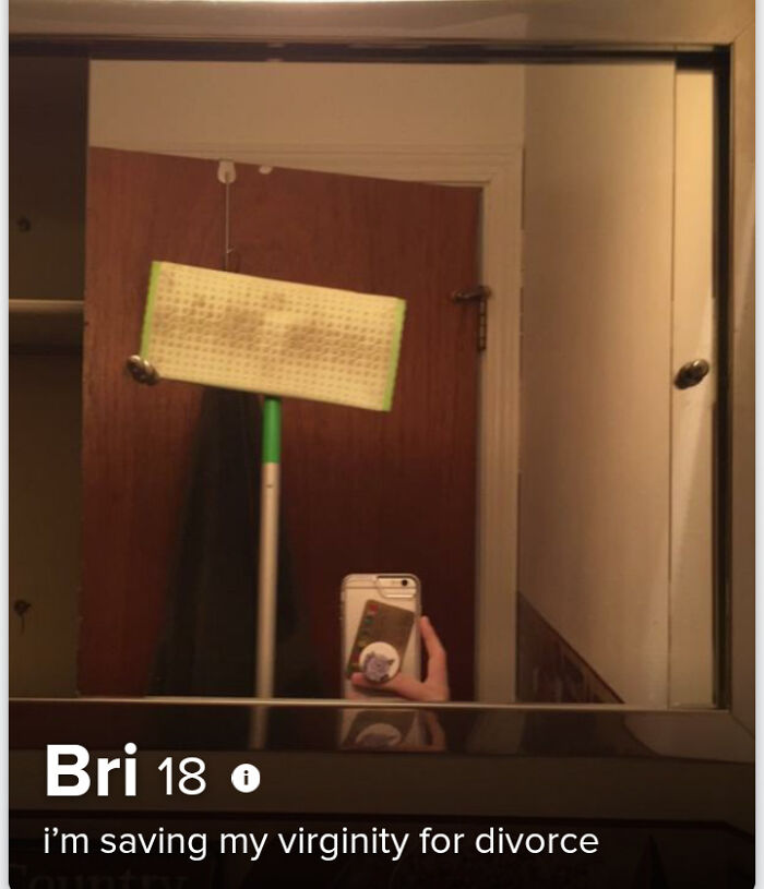 Tinder profile with a mirror selfie showing a mop and a phone, featuring a bold and unusual dating bio.