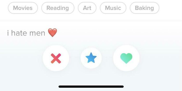 Tinder profile showing interests and a controversial bio with dating app swipe buttons below the text.