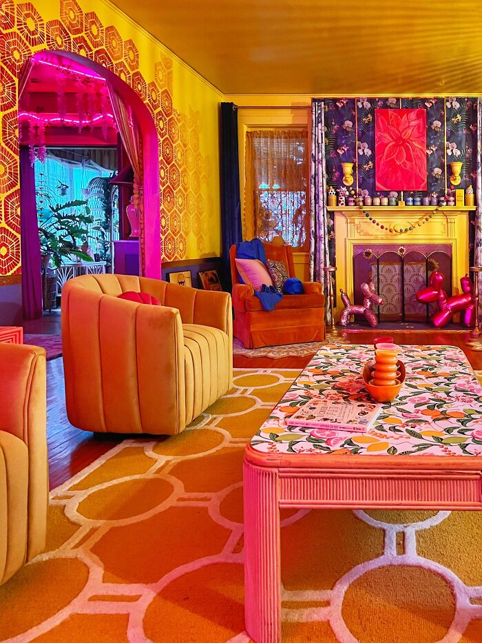 Colorful living room embracing more is more decor style with bold patterns, vibrant furniture, and eclectic home accents.