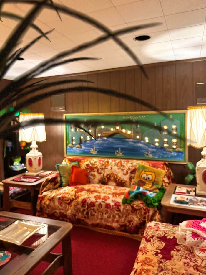 Eclectic living room showcasing more is more home decor style with vibrant patterns, bold colors, and layered furnishings.