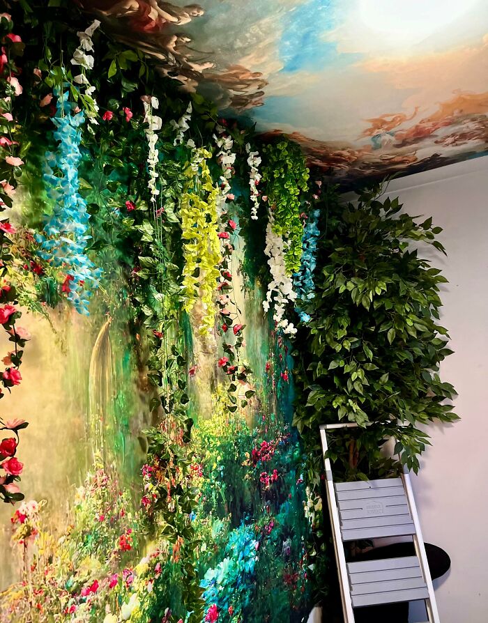 Indoor garden-themed home decor with abundant hanging flowers and greenery embracing a more is more home design style.
