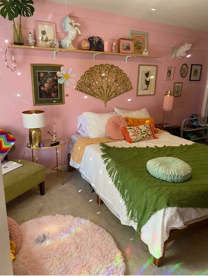 Eclectic bedroom decked out with colorful pillows, vintage art, and decorative items embracing more is more home decor style.