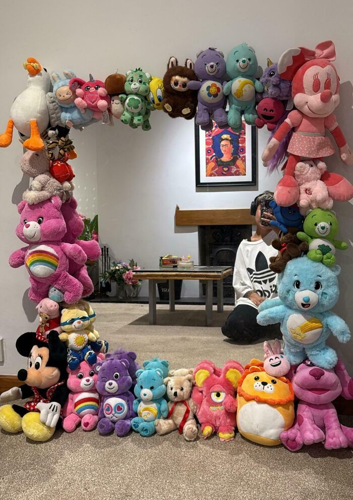 Mirror framed with mismatched plush toys in a DIY project, creating a deeply cursed and chaotic decorative effect.