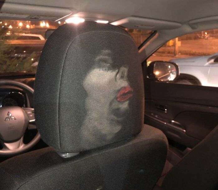 Car headrest with a funny face illusion created by light and shadow, showcasing a humorous photo that says it all instantly.