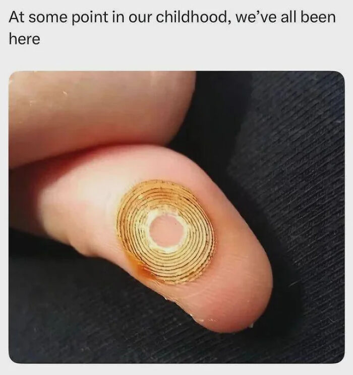 Close-up of a finger with a sticker design on it. People often need jokes explained to them.