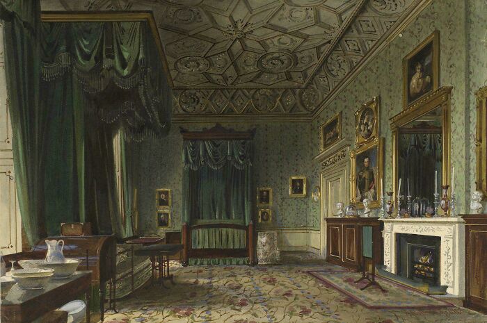 Victorian era interior with ornate ceiling, dark green drapes, antique furniture, and framed portraits on patterned wallpaper walls.