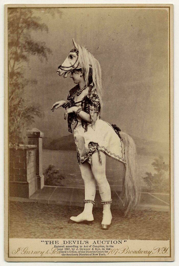 Victorian era photo of a child in an elaborate horse costume showcasing period fashion and theatrical style.
