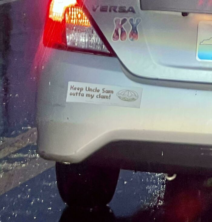 Car bumper sticker with political message about Uncle Sam and clam on a gray Nissan Versa