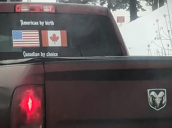 Bumper sticker with American and Canadian flags and text about American birth and Canadian choice