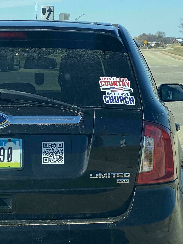 Black car with sticker saying This is our country not your church