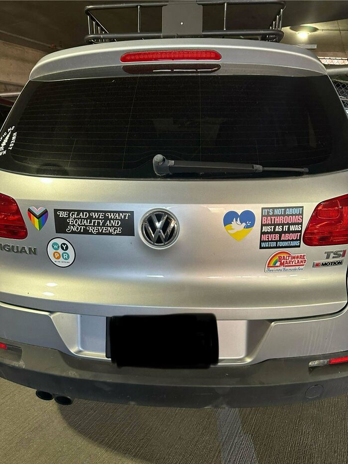 Car with multiple social justice and equality bumper stickers