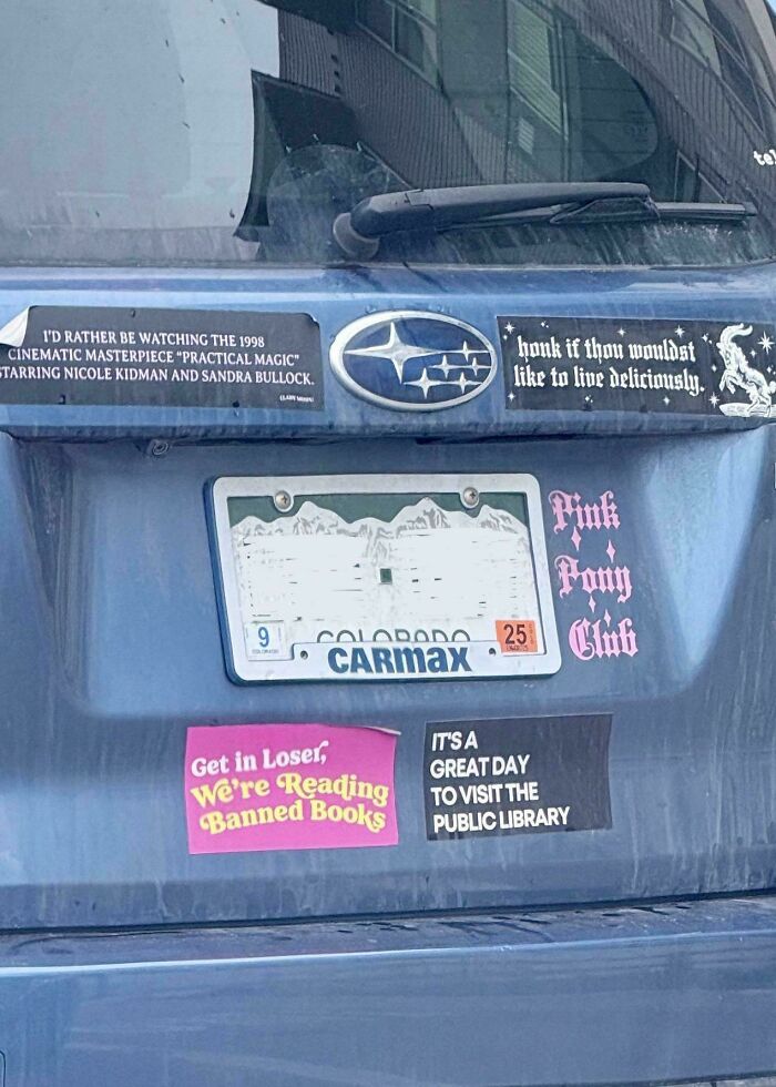 Wild bumper stickers on a car including banned books and public library themes