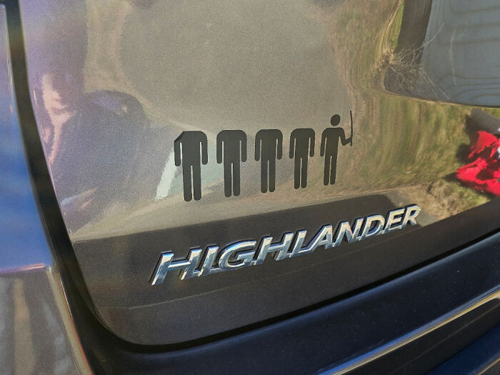Highlander car with family sticker showing one figure holding fishing rod