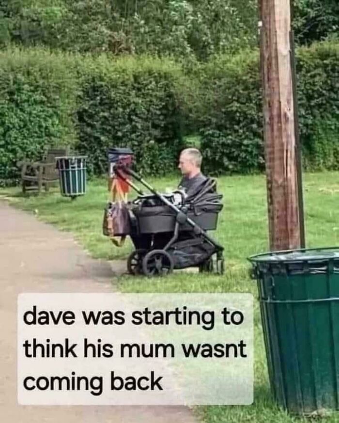 Man appears to be sitting in a stroller in a park, creating a misleading and confusing photo that seems like a glitch.