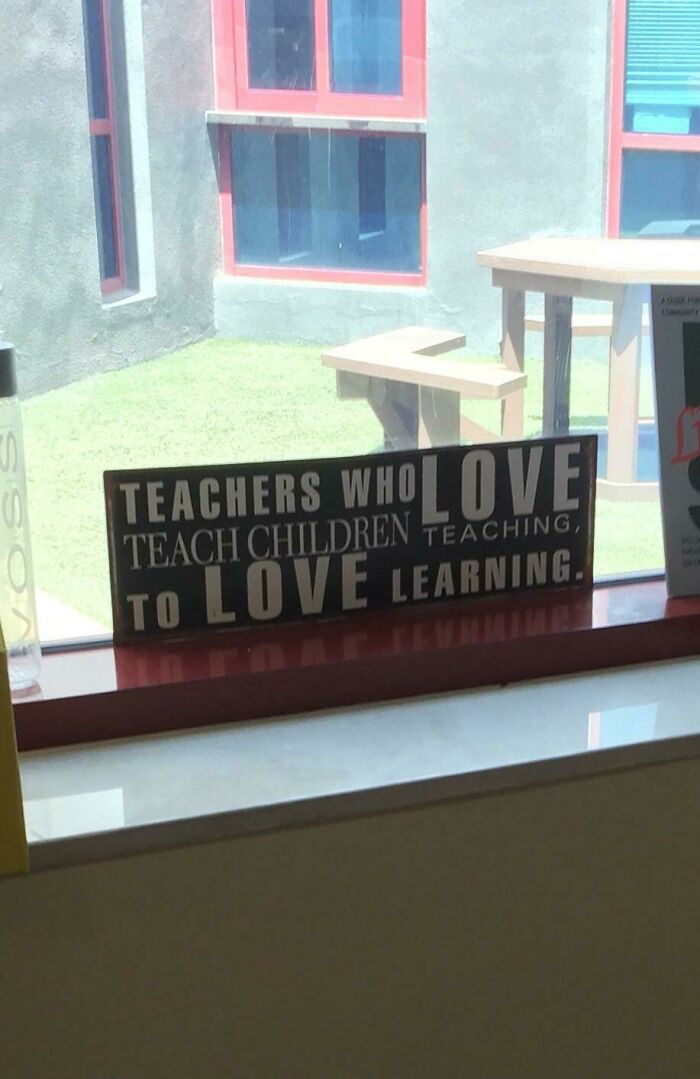 Funny sign with mixed-up text about teachers loving teaching and children loving learning, a comedic gold moment.