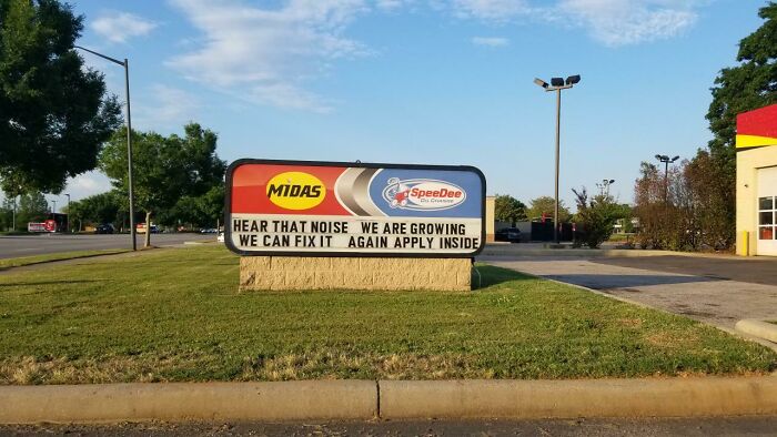 Humorous business sign with confusing message at Midas and SpeeDee, showcasing signs that went so wrong comedic gold.